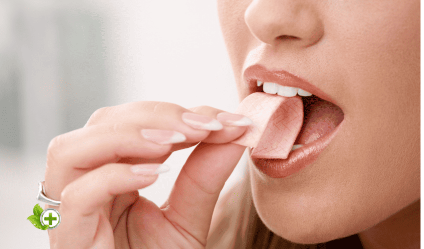a woman about to eat gum in a post about Bad Breath From The Gut