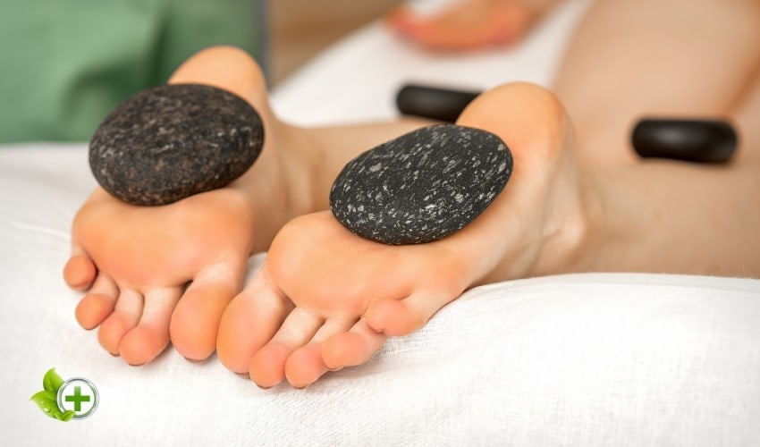 A person going for a hot stone massage in a post about Foot Skin Peeling
