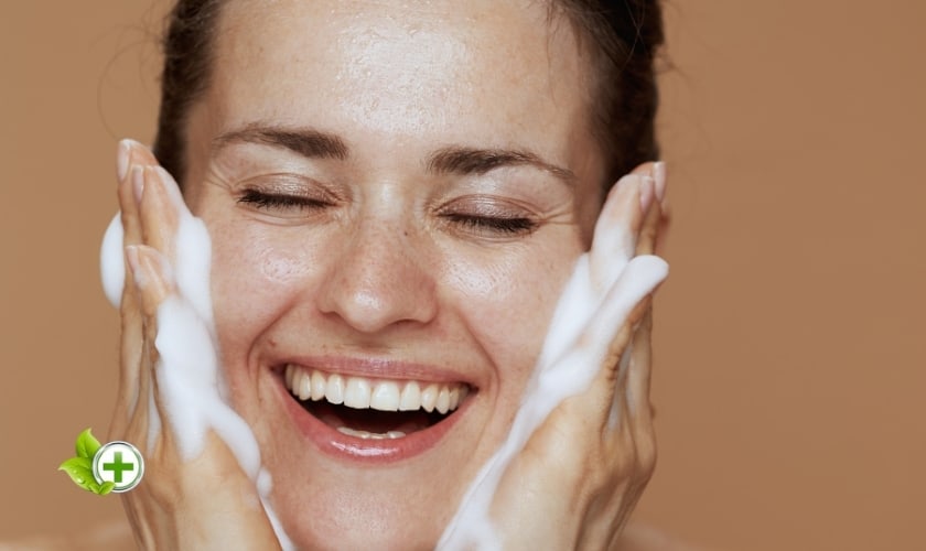 applying a gentle, foamy cleanser on the face in a post about dehydrated skin